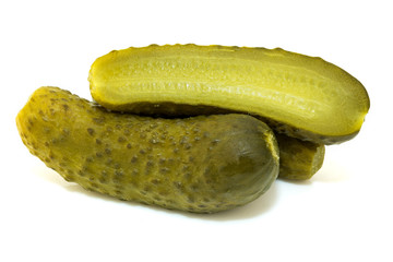 One pickled cucumber cut in half on white background. Marinated pickled cucumber isolated on white background. 