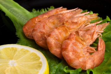 Grilled tiger shrimps on grill with spiced and lemon