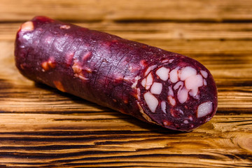 Smoked salami sausage on a wooden table