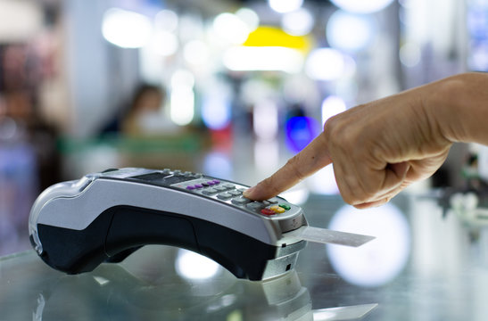 Paying by credit card with   paying with contactless credit card with a credit card reader machine.