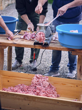 Crop people near mincing machine