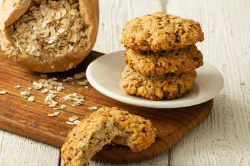Oatmeal cookies with milk on tray on rustic wooden table