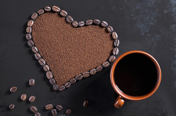 Heart of beans and brown cup of coffee