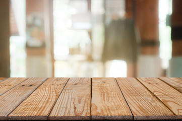 empty wooden table with blur coffee cafe background.