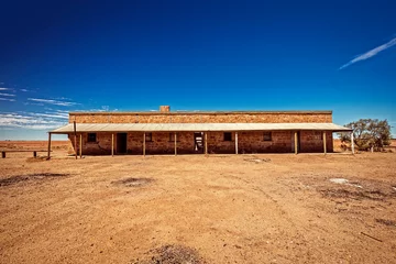 Fototapeten Australia – Outback desert with an old abandoned vintage railway station near the old Ghan under blue sky © HLPhoto