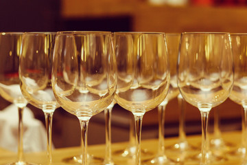 Wine glasses in row on bar