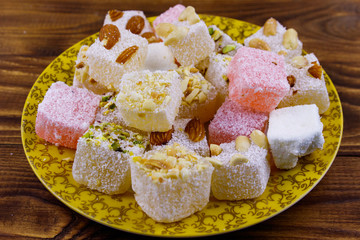 Turkish delight in a plate on wooden table