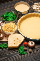 shortbread dough for baking quiche tart in baking form and ingredients
