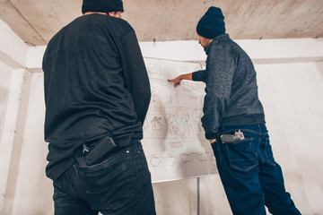 Robbers taking notes on the map