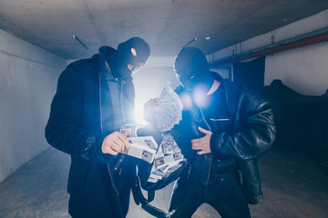 Gangsters taking money from the bag