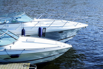 Modern motor boats on the water. Moored on the water at the pier