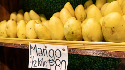 Mango in a wooden shelf, local food market, bohol island, cebu, Asia