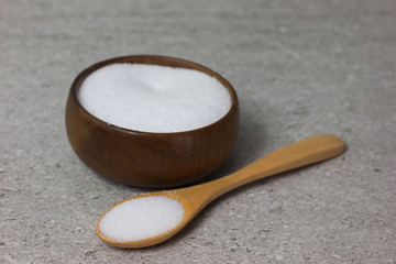 Salt in Cup made of wood with spoon  
