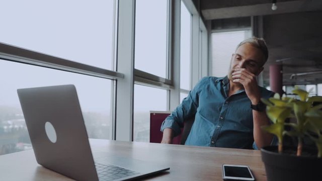 Overworked minded man having headache after working day