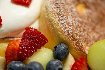 Pancake with strawberry, blueberry, banana, berry sauce and mascarpone cheese cream.