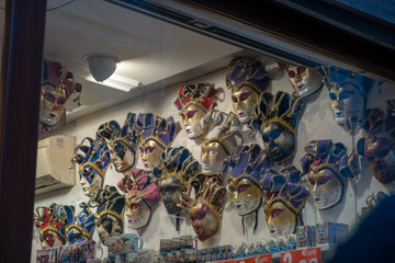 The masks of the Venice carnival hung in a shop. Venetian masks representing the carnival.