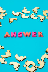 Answer Search Concepts. Concepts search answer. footprints and the word answer on a blue background. vertical photo.