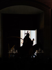 Silhouette of the image "la burreta" before leaving the collegiate church of Xàtiva for the procession of the palms, on Palm Sunday (Holy Week of Xàtiva)