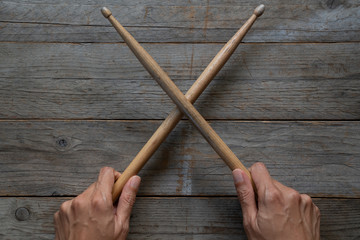 hand holding drum stick on black table background, music practice concept