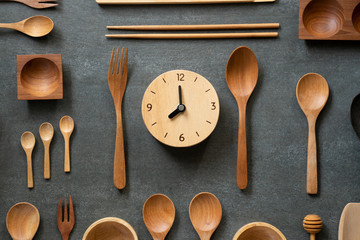 kitchen utensils for cooking and clock on the wooden table, food prepare concept