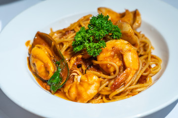Spaghetti seafood with tomato sauce on the white