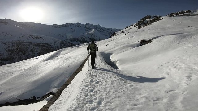 Man trekking in the snow, italian Alps. Gran Paradiso National Park, Italy