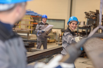 Happy female worker smiles to colleague who is helping her to mo