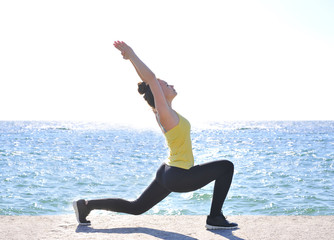 Beautiful girl doing yoga by the sea. Healthy lifestyle