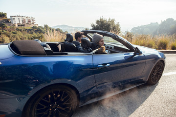 Driving convertible sports car by road