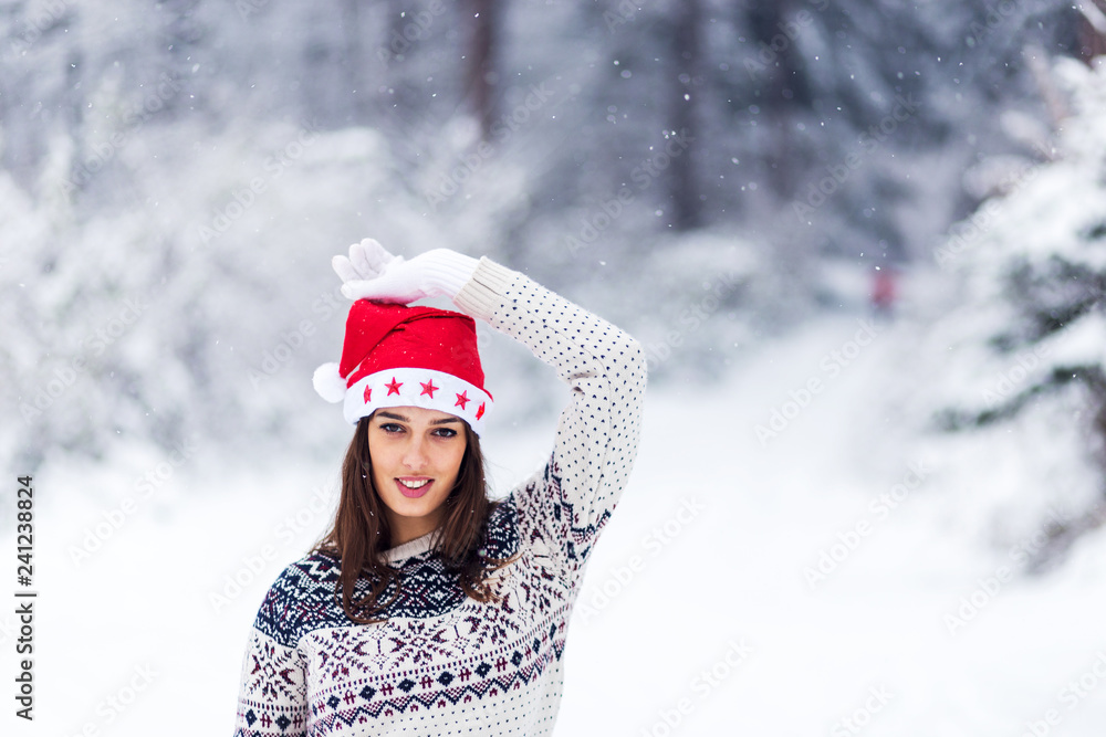 Wall mural portrait of young beautiful woman with santa cap