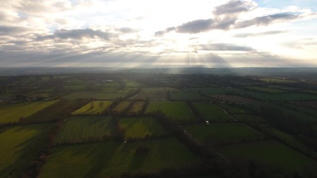 Normandy fields separated by hedges and ditches sunset time with clouds. Aerial drone shot