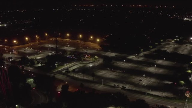 Theme park parking lot aerial night footage
