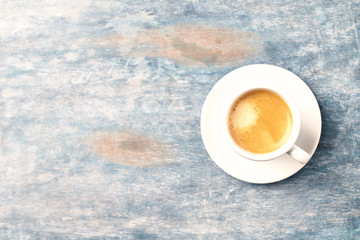 Cup of coffee on rustic wooden background. Top view. Copy space.