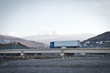 Truck circulating on a bridge over a dry river in Oued Laou, Chaouen province, in the Tangier...