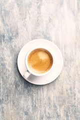 Cup of coffee on rustic wooden background. Top view. Copy space.