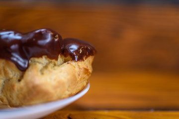 chocolate eclairs on a wooden background