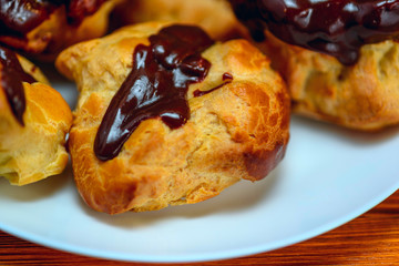 chocolate eclairs on a wooden background