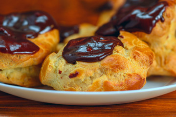 chocolate eclairs on a wooden background