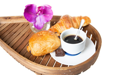 wooden tray with French coffee with croissant pastry and chocolate