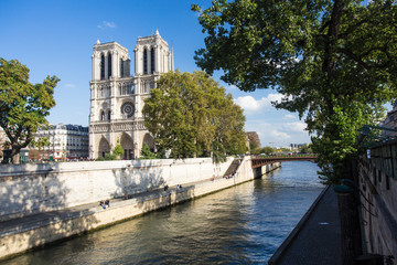 Fototapeta na wymiar View of Notre Dame Cathedral in Paris France along Seine River 