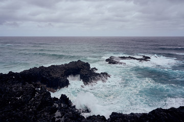 Tenerife: Black Stone Coast overlooking the rough Atlantic Sea on a rainy day