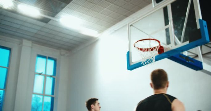 High school team playing basketball indoors, practicing combinations and drills. 4K UHD