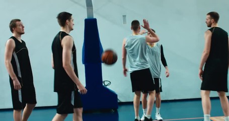 High school team playing basketball indoors, practicing combinations and drills. 4K UHD - Powered by Adobe