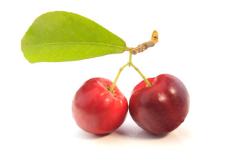 fresh organic acerola with green leaves, isolated on white background with clipping path
