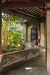 Entrance into small courtyard with tree planting in Yu or Yuyuan Garden in  the old city of Shanghai