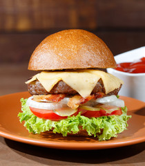 burger and french fries on the wooden table.