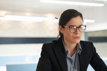 Portrait of Unhappy Serious Businesswoman in Office With Copyspace