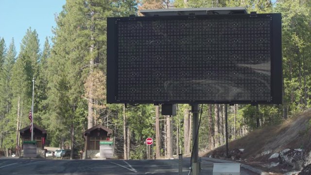 Gov't Shutdown Sign, Long Shot. Traffic passes warning sign outside Yosemite National Park days the Dec 2018 partial government shutdown over President Donald Trump's US-Mexico border wall.
