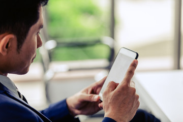 Closeup hand sian businessman smile work happy relaxation with smartphone in office