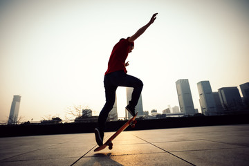 Skateboarder skateboarding at sunrise city .
